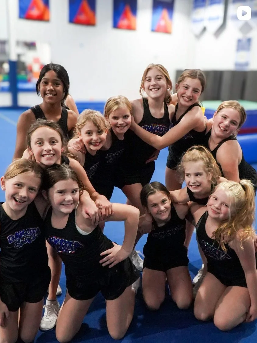 Group photo of cheer athletes during practice.