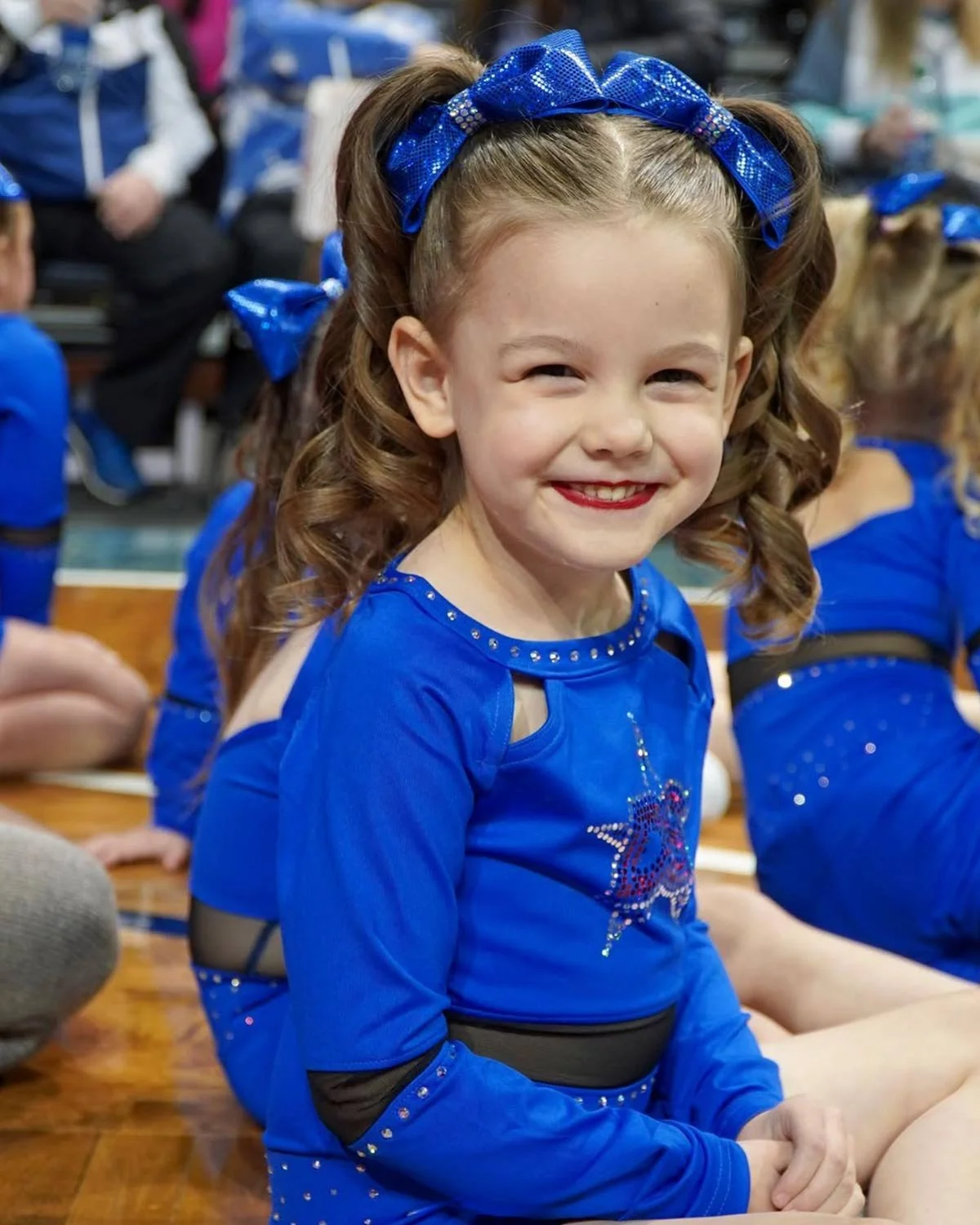 A young performance league athlete posing for the camera at a competition.