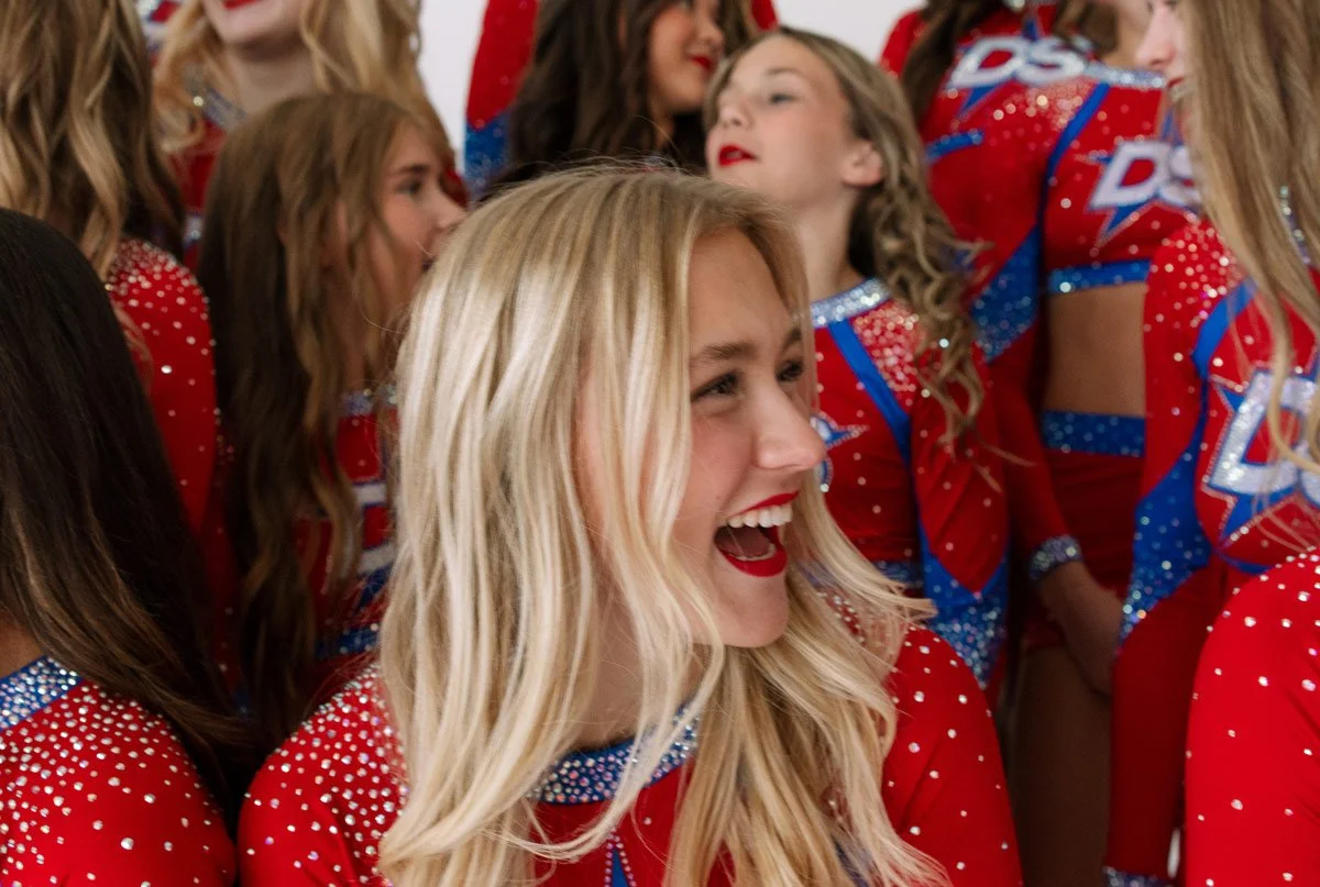 Candid photo of Dakota Spirit cheerleaders having fun during a studio photo shoot.