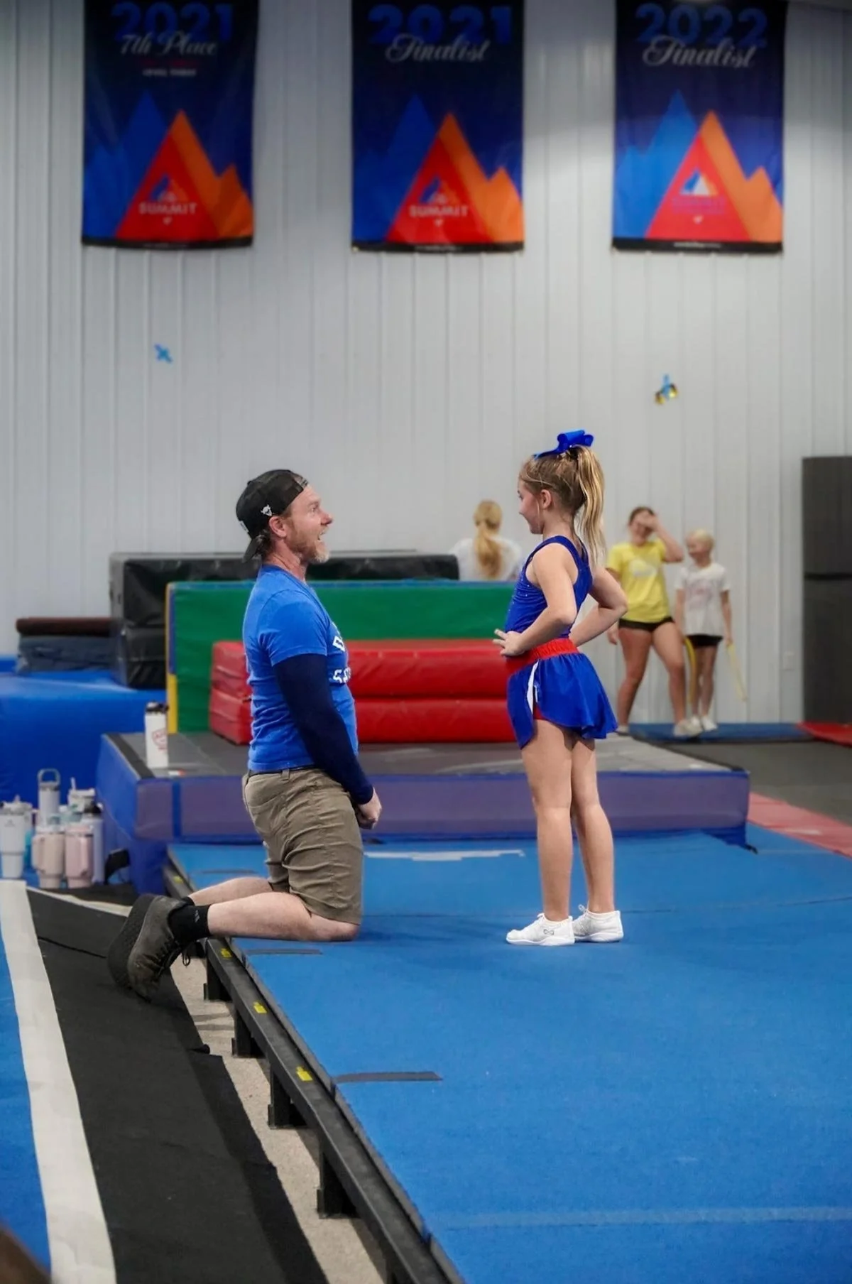 An Dakota Spirit coach giving instruction to a young athlete.