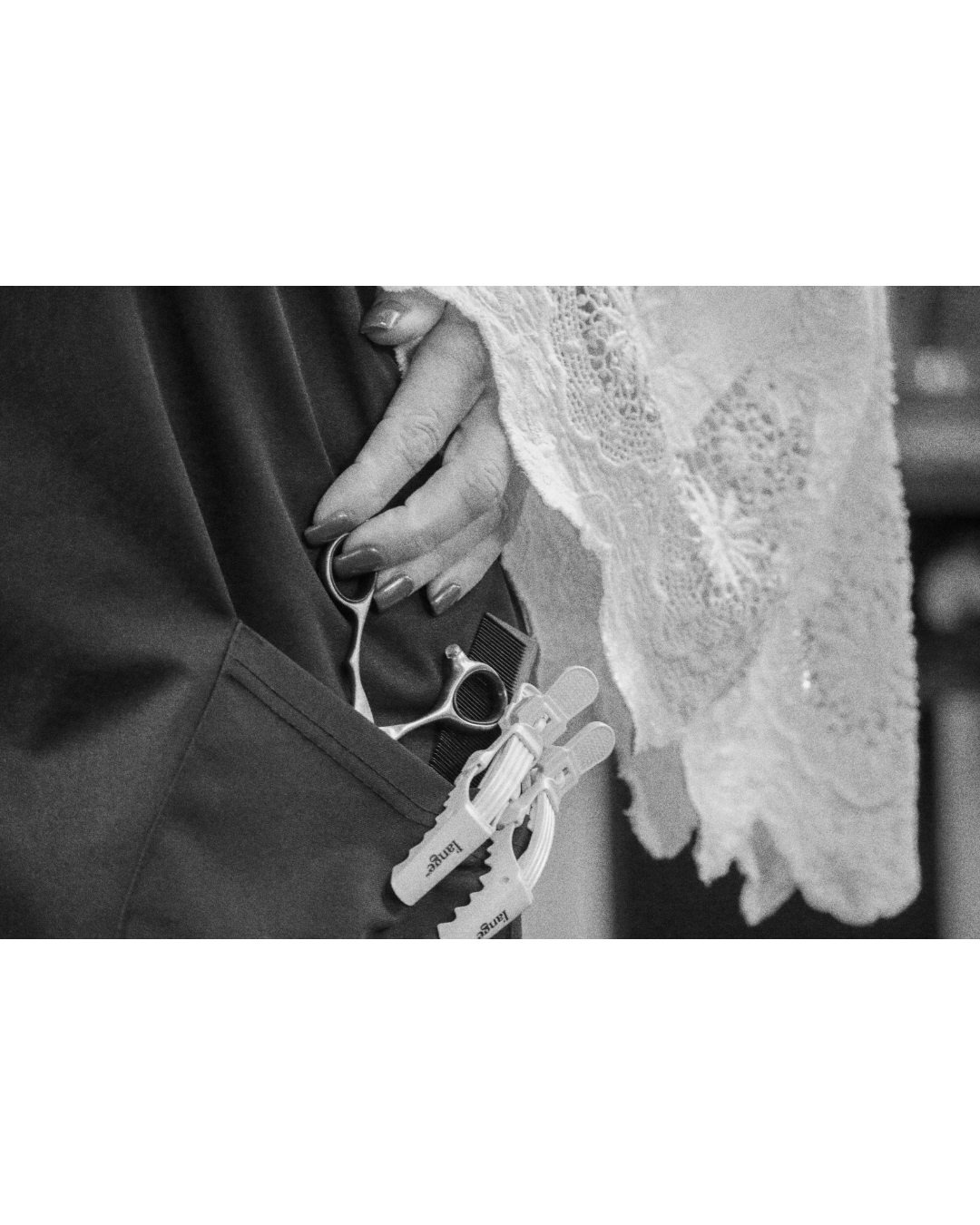 A person with manicured nails and lace sleeve pulling out scissors, hair clips, and comb from a pocket. Julie, the founder of Radiant Styles by Julie