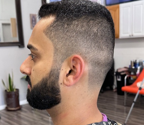 Men’s low fade haircut with a sharp beard line-up at a Chicago
barbershop, highlighting clean blending and precision grooming