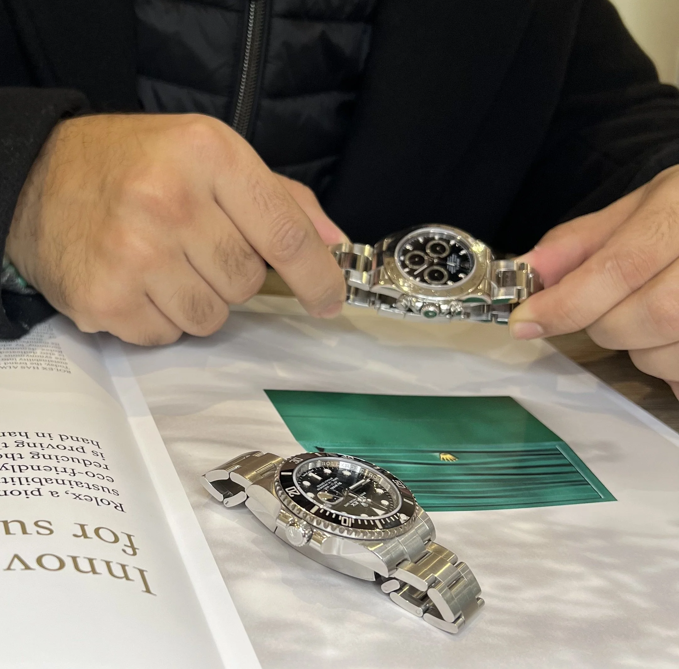 Private Rolex dealer inspecting Daytona and Submariner during client consultation in London