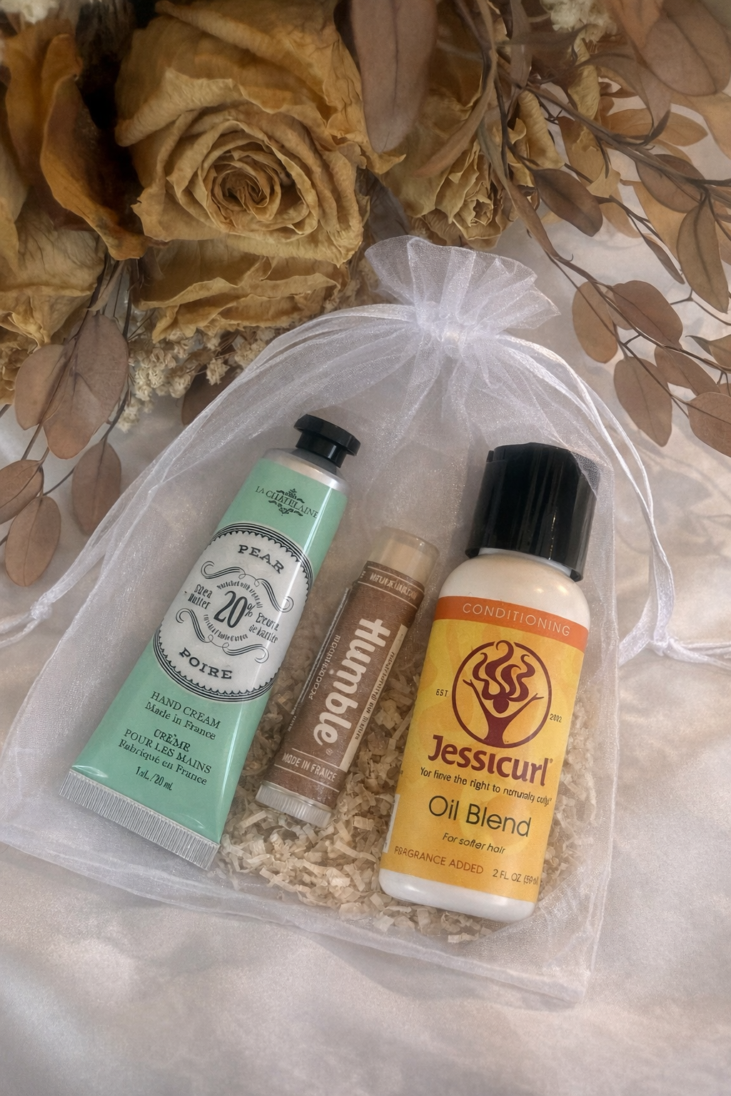 Self care essentials included in Silken Grace comfort gift box hand cream lip balm and nourishing hair oil wellness recovery support gift box