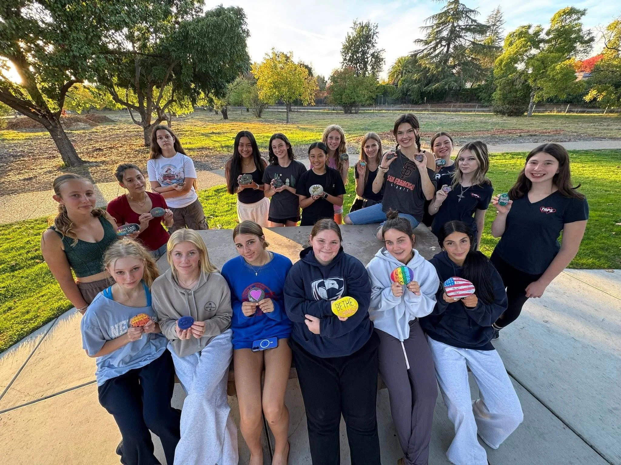 Teens holding rocks they painted