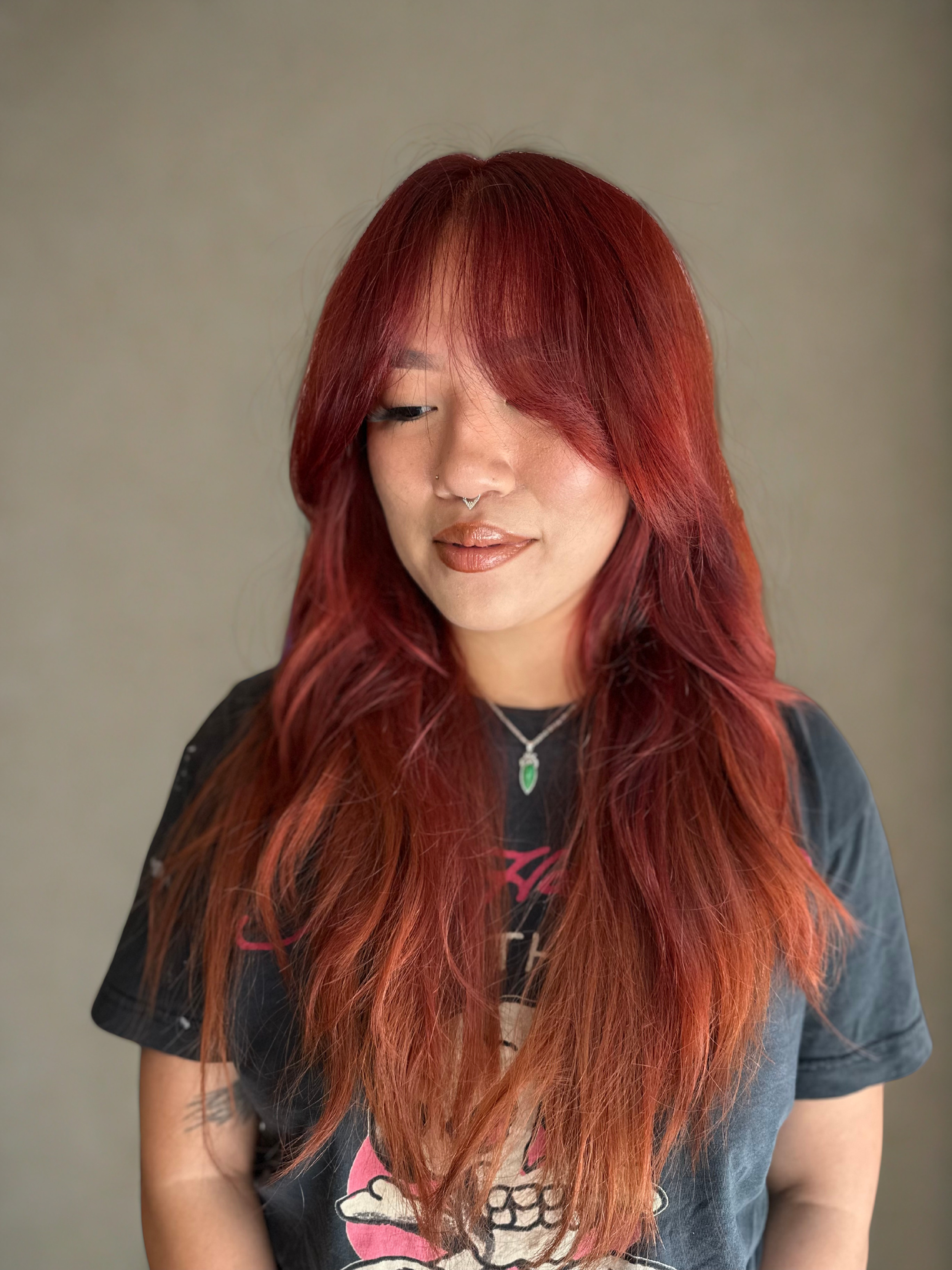 Luxe long copper hair with vibrant fiery tones and a glossy, dimensional finish.