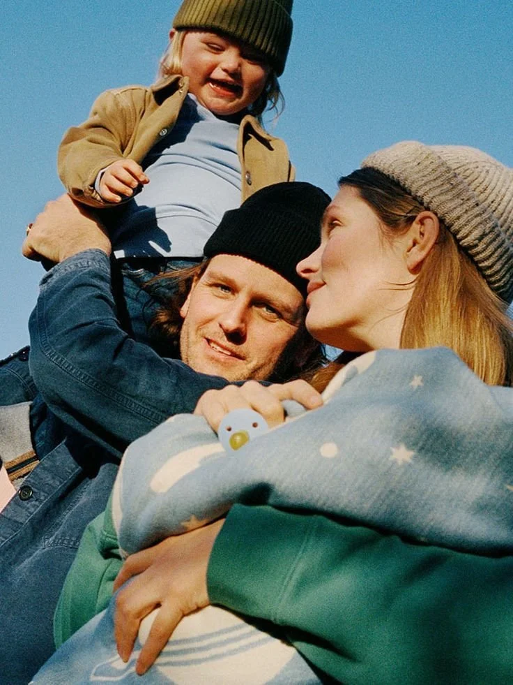 A family of three, a man, woman, and a young child, enjoying time outdoors engaging in natural learning, and speech development in Bellingham, Washington
