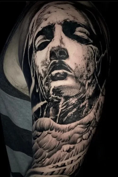 realistic angel blackwork arm tattoo done at Black Crown Studio Austin tx