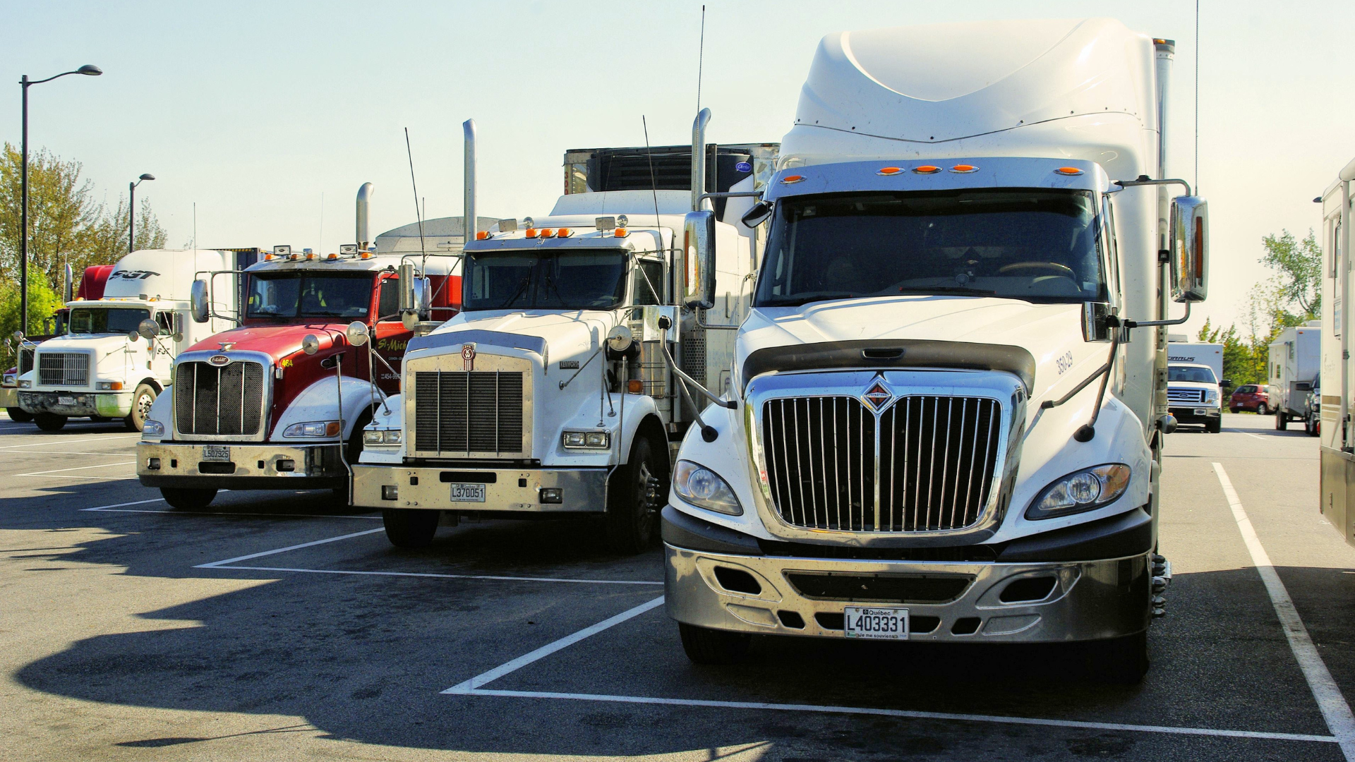 Multiple commercial trucks showing fleet insurance pricing differences