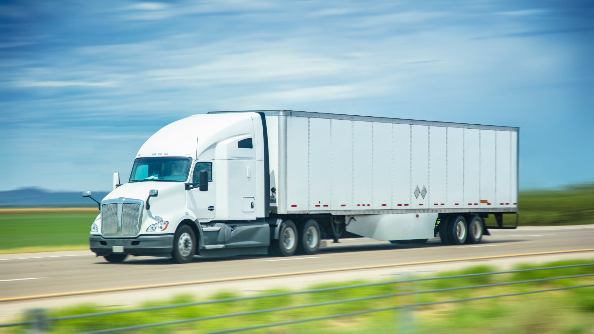 Commercial truck on open road showing high Texas insurance premiums