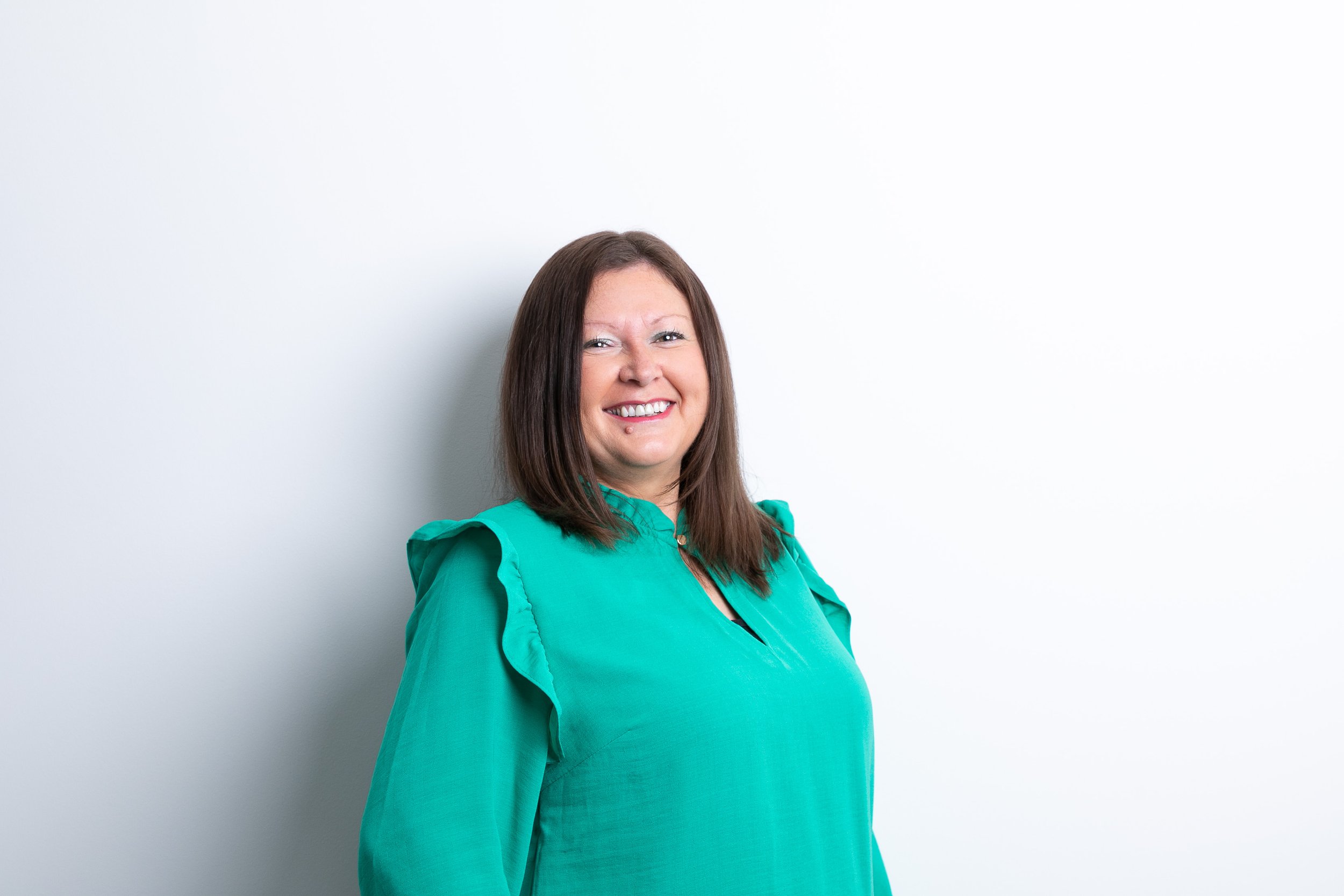 Lady with brown hair smiling a the camera