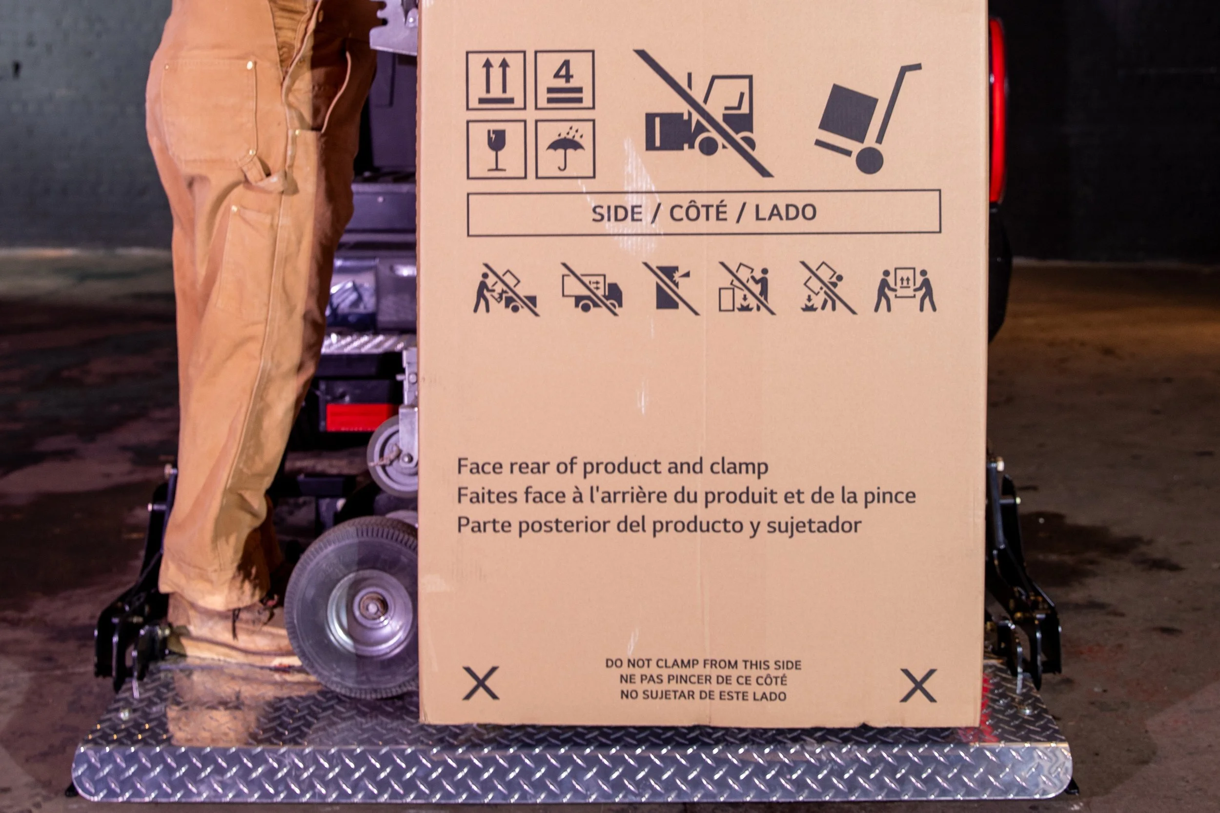 A large cardboard box on a dolly with instructional labels on the ProLiftgate.