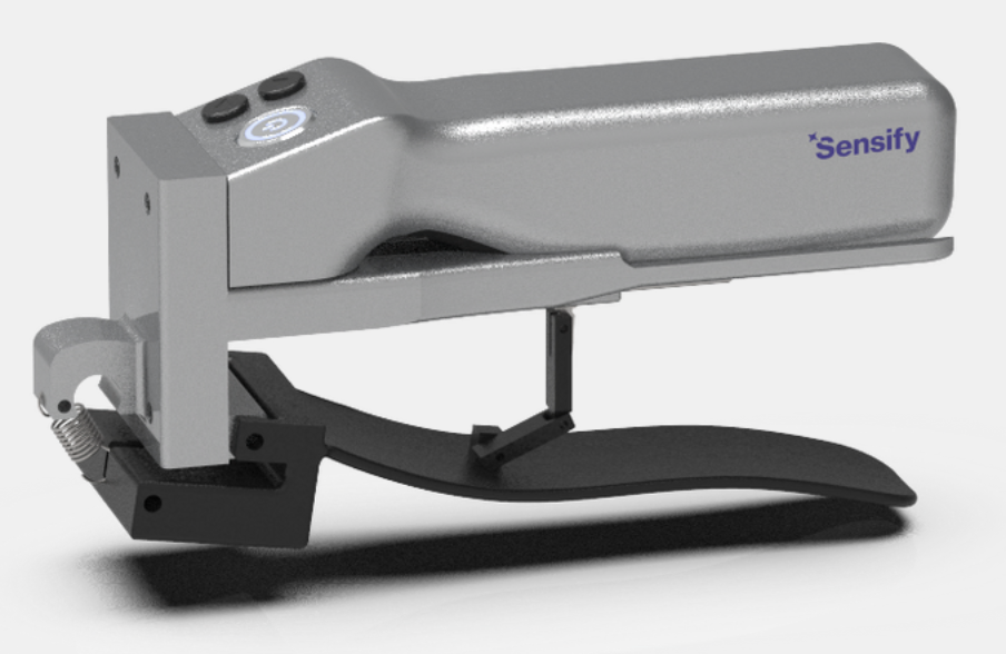 A handheld medical device labeled 'Sensify' in purple text, with two buttons on top, mounted on a black stand with a spring mechanism.