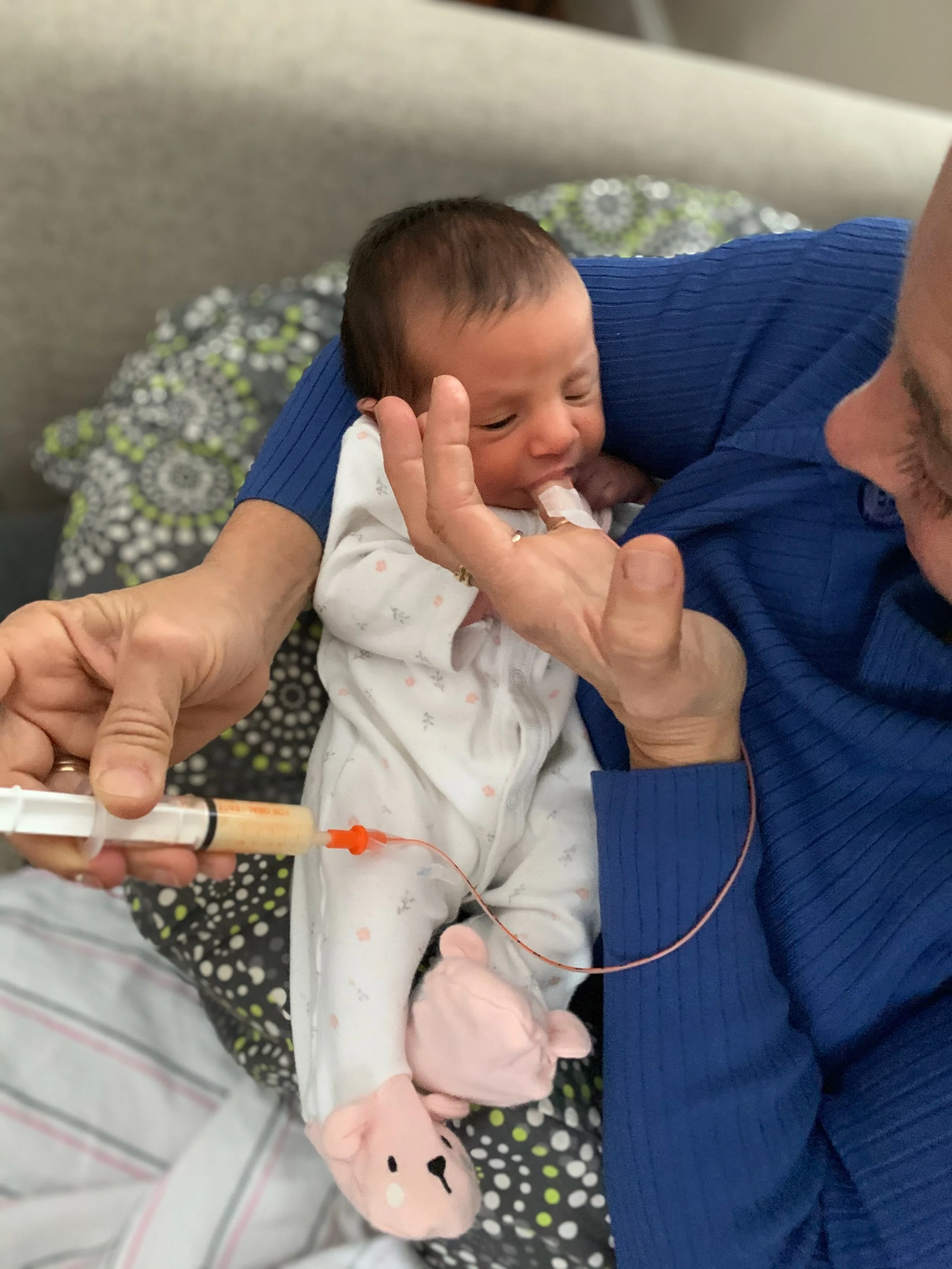 Baby fed with a supplemental nursing system, alternative feeding methods