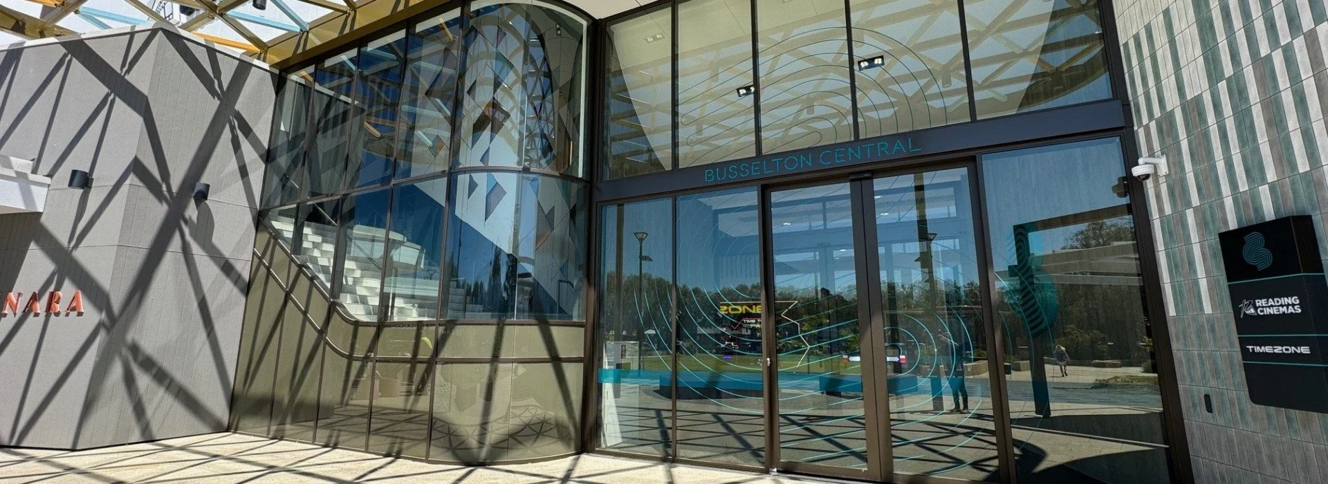Entrance to Busselton Central shopping mall with glass doors and modern exterior design.