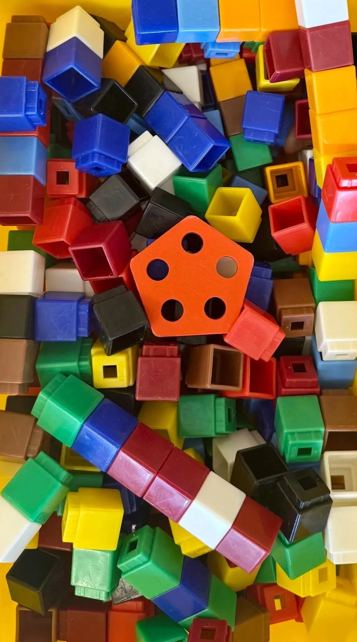 Close up of box of different colored building blocks