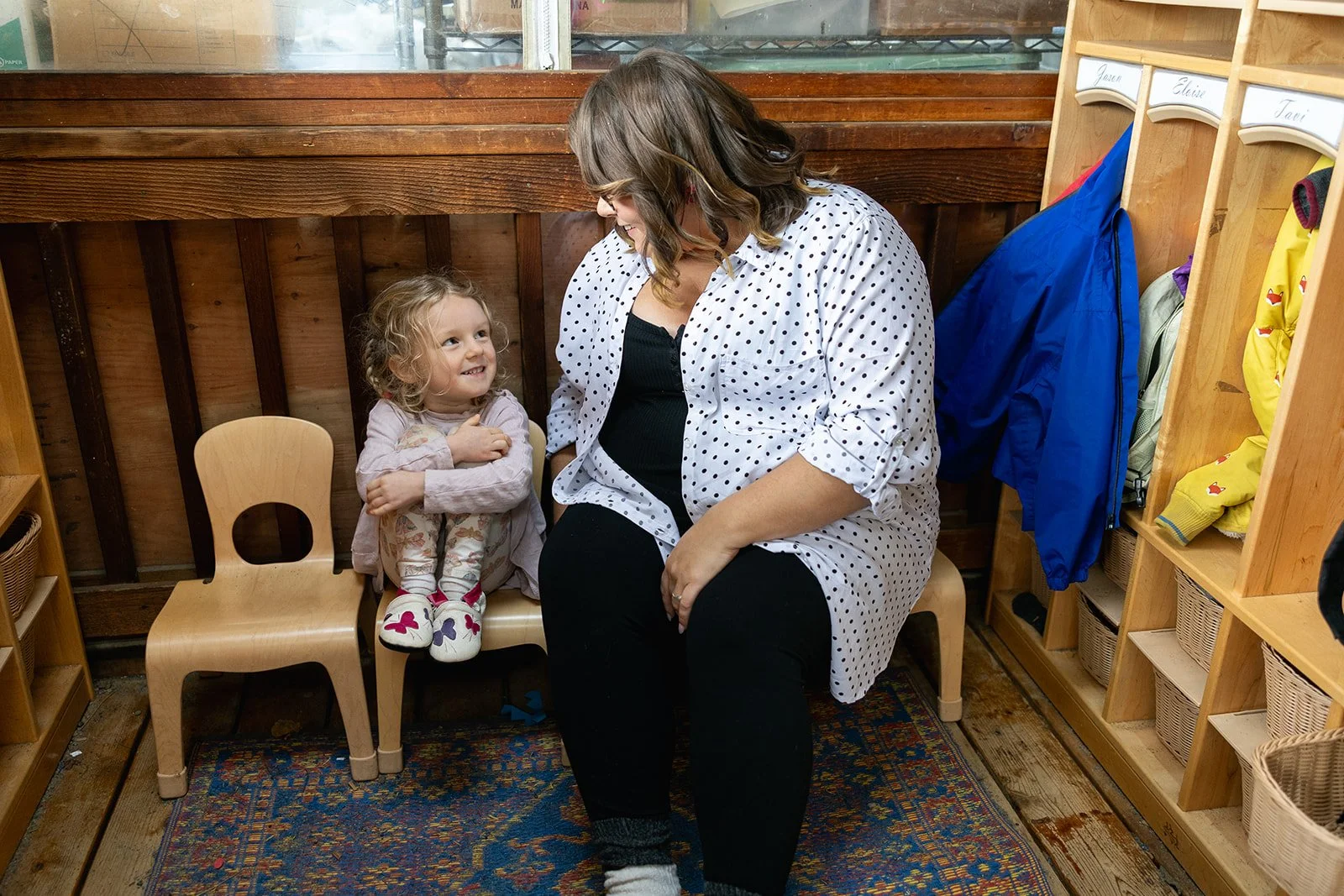 Teacher and child sitting and smiling at each other