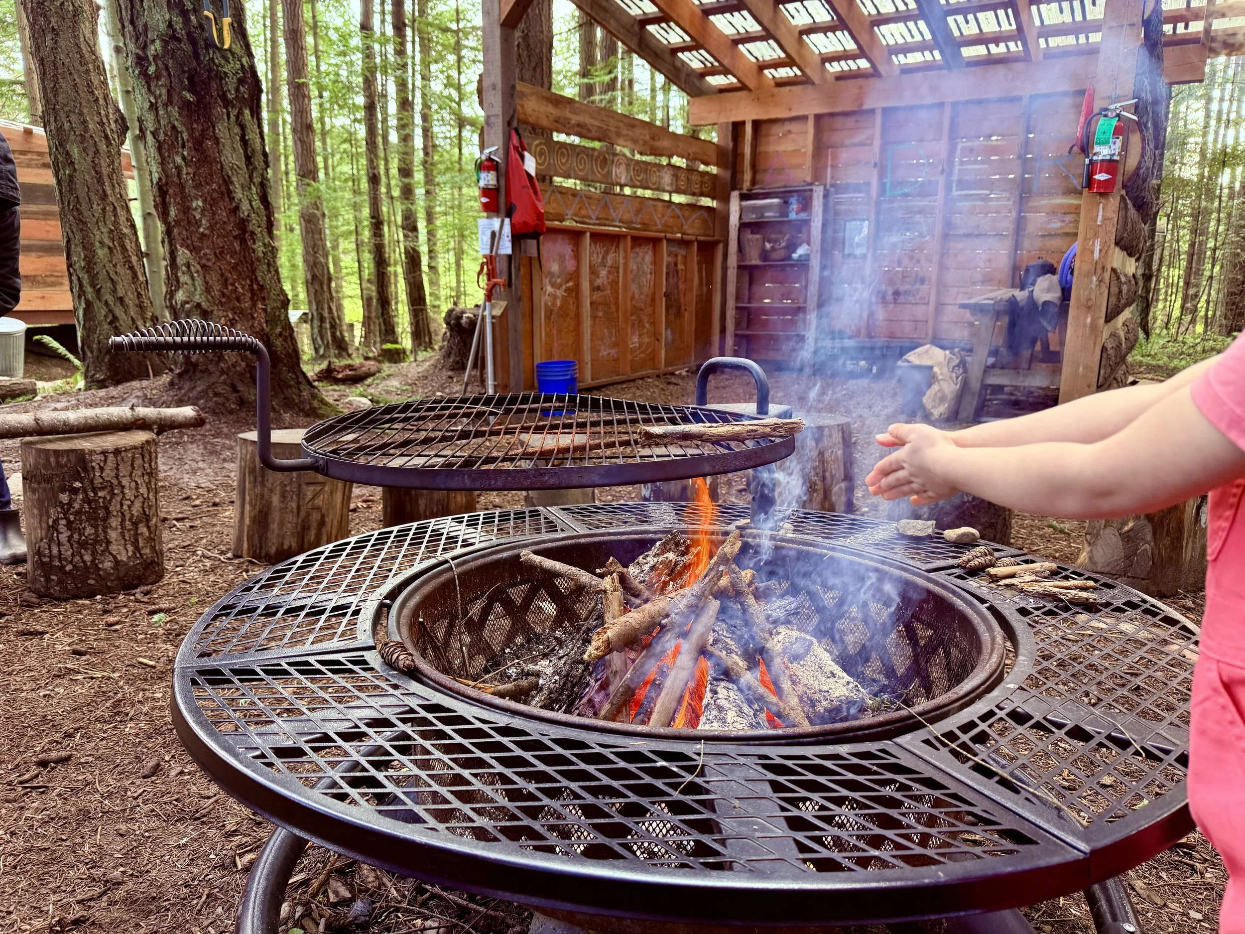 Child warming hands over fire pit
