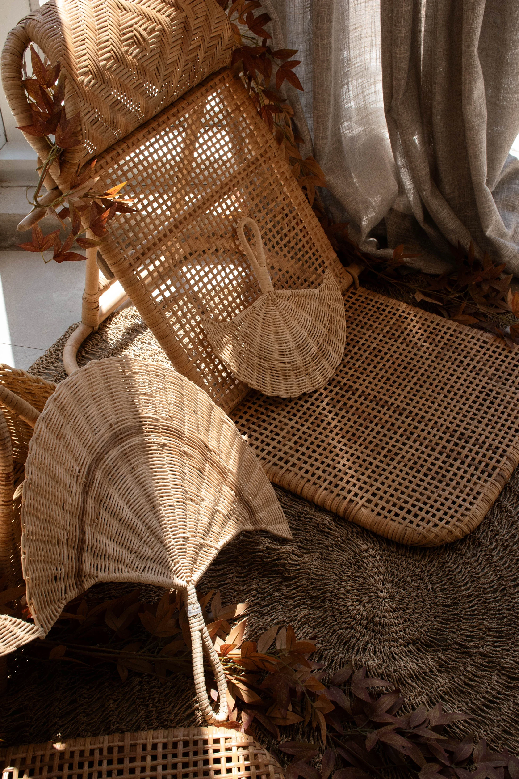 picture of several boho style home decor items, including  a hand fan and beach chairs