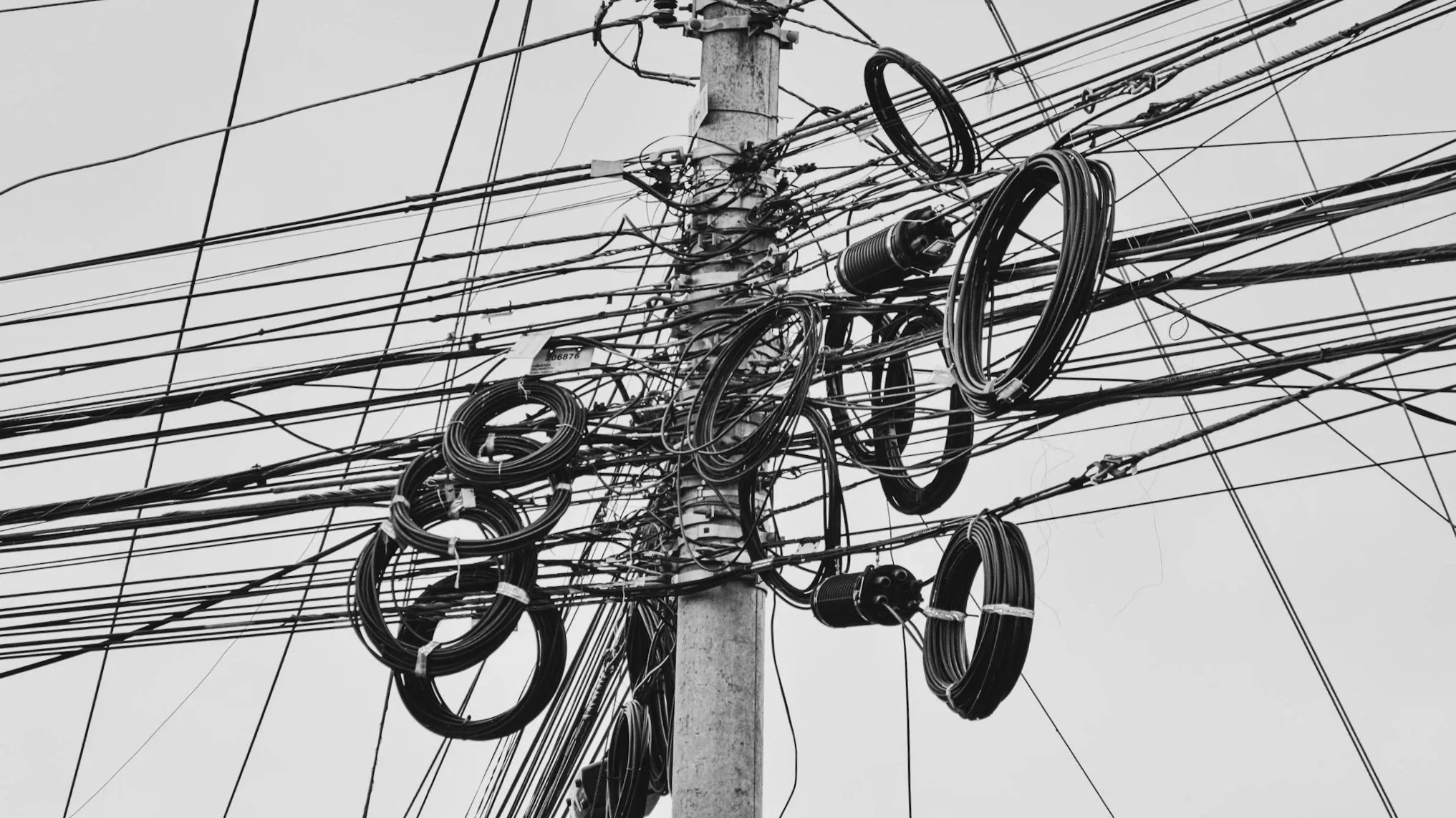 A  tangled electrical wires stretching in multiple directions as a metaphor for the chaos of today's culture.