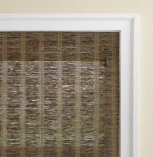 Close-up of a window with a bamboo or wooden blind covering it.
