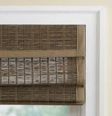 Close-up of woven bamboo or rattan window blinds installed inside a window frame.