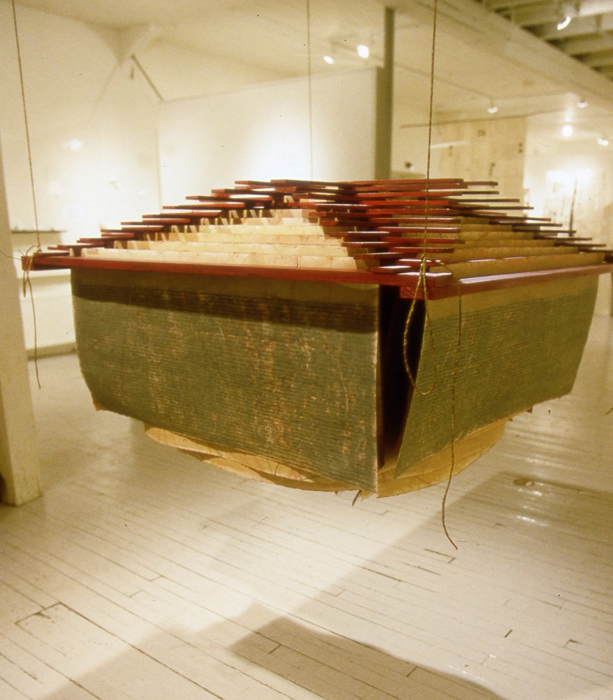 Library, 1997. Book Sculpture, oil pastel acrylic and graphite on paper, wood slats, yacht marline attachments, installation view. Dimensions 36 x 48 x 48 inches.