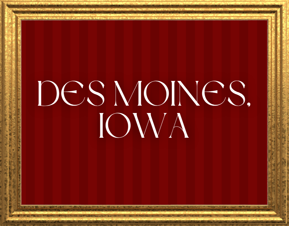 A framed sign with a red background and white text that reads 'Des Moines, Iowa.'