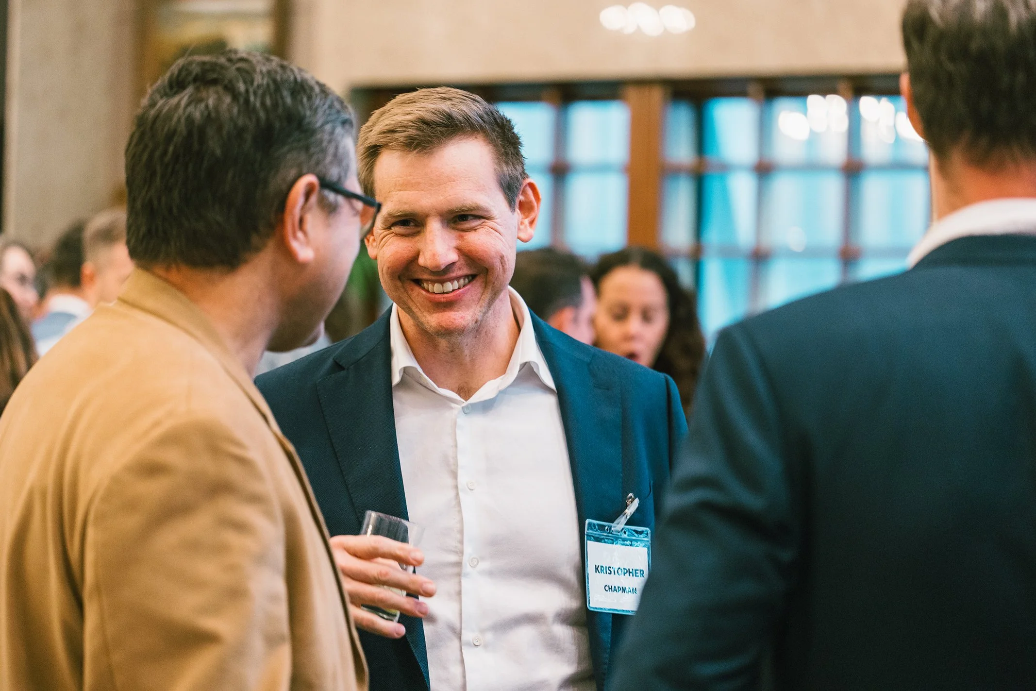 Professional man smiling while building connections at a business event