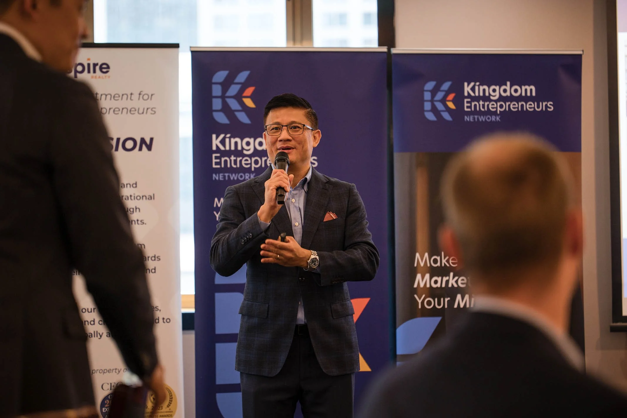 Colin Lee speaking in a microphone at KEN event