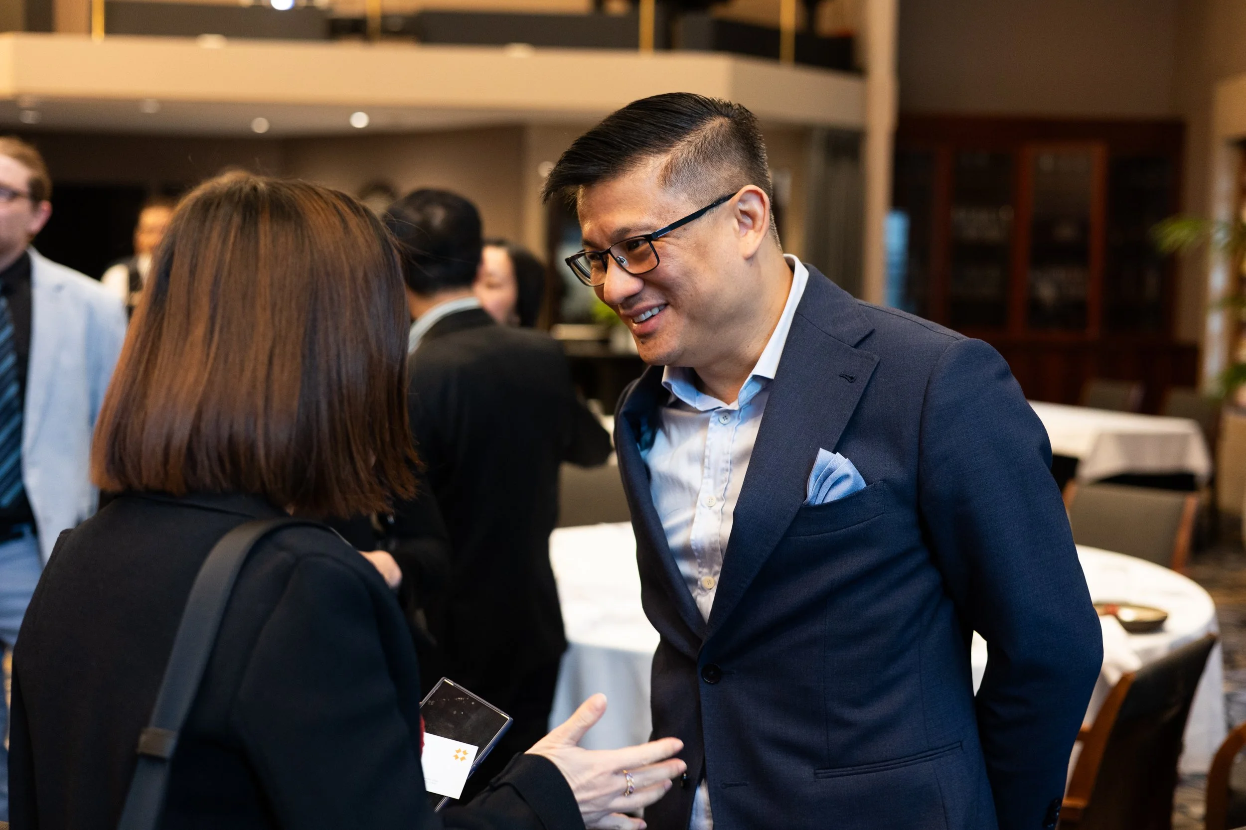 Business professionals engaged in conversation at a networking event