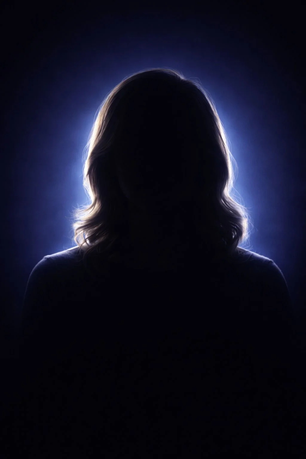 Silhouette of a woman with shoulder-length hair backlit by a blue light, creating a glowing outline around her head and hair.
