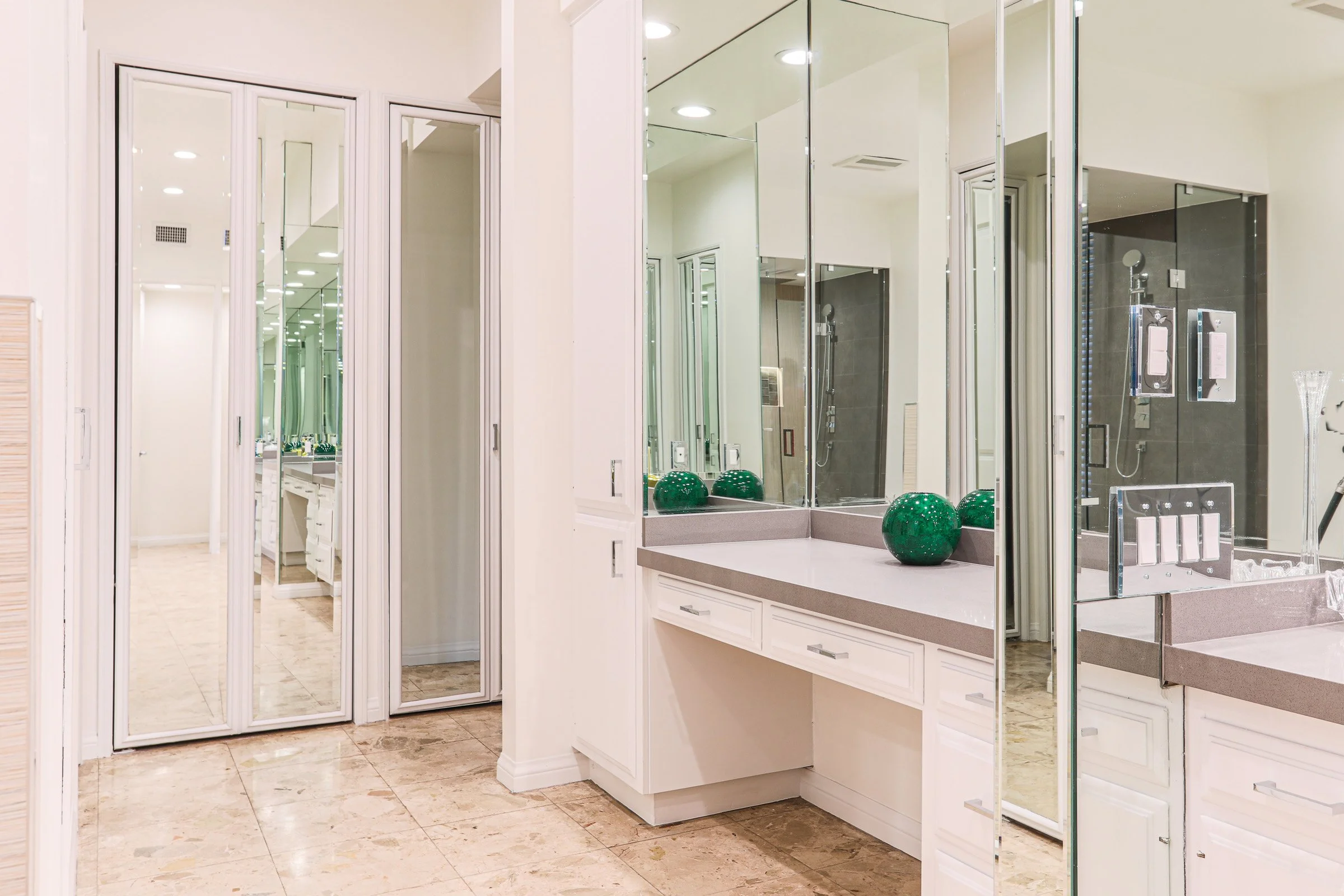 Custom bathroom vanity and dressing area with mirrored cabinetry in Newport Beach luxury home