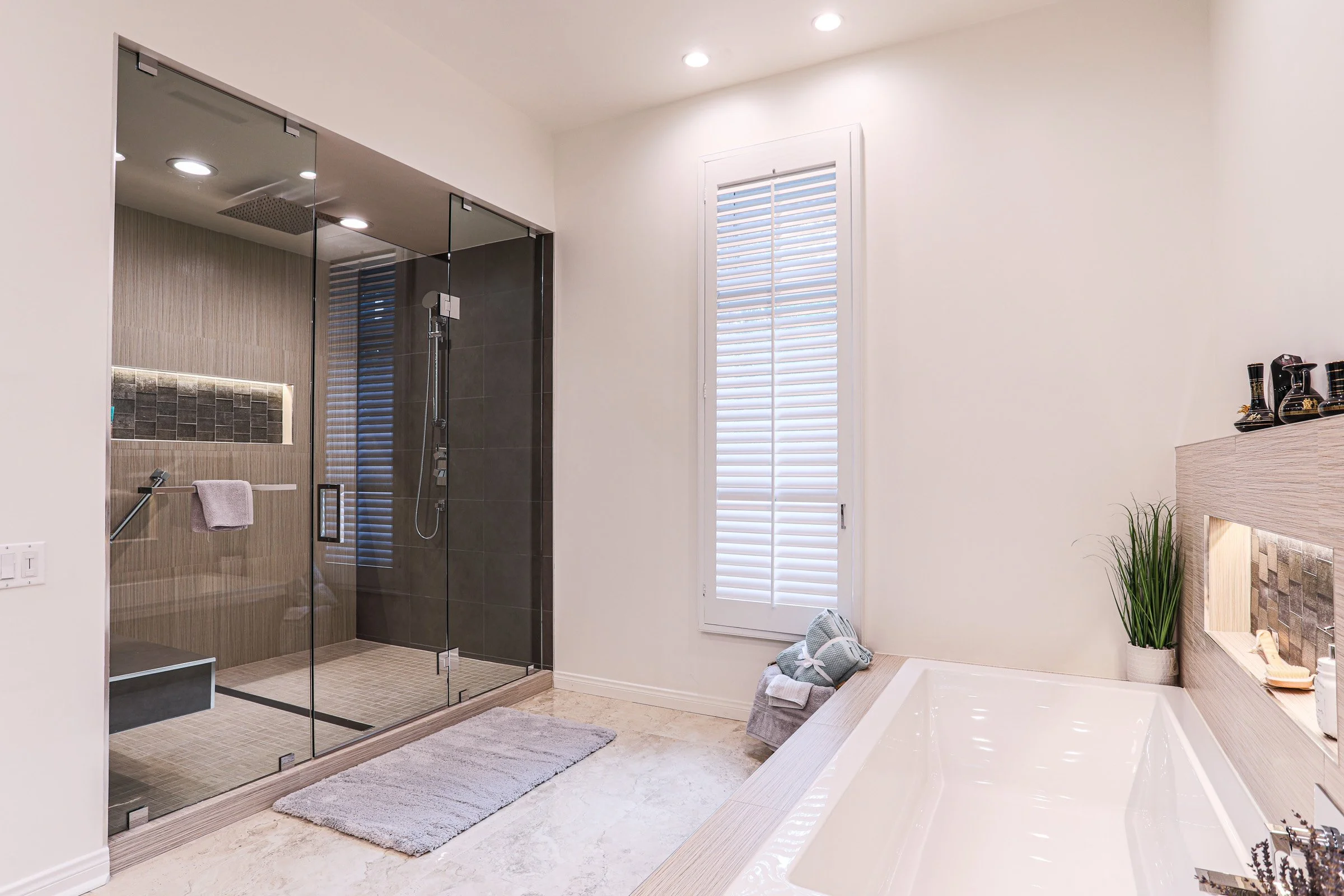 Glass walk-in shower and soaking tub combination in upscale Newport Beach bathroom remodel