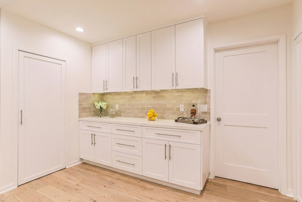 Custom Irvine kitchen remodel coffee bar with white shaker cabinets, quartz countertop, open shelving niche, and integrated storage.