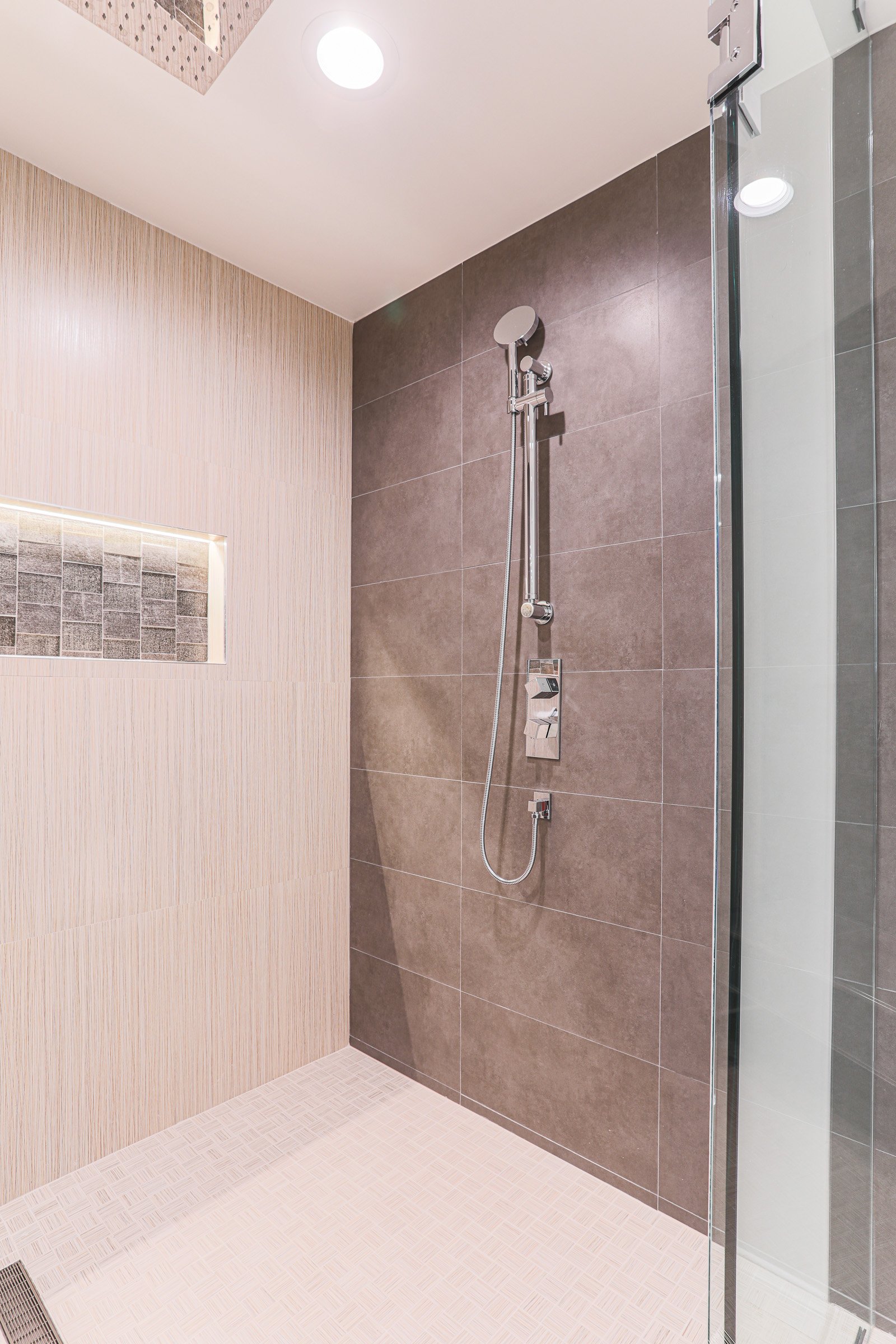 Modern walk-in shower with large format tile and recessed niche in Newport Beach bathroom remodel