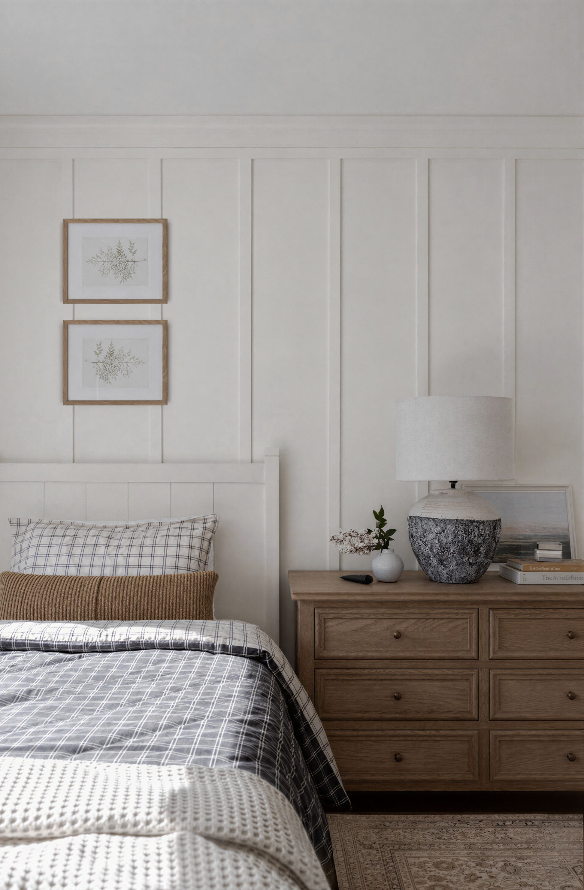 A cozy kids bedroom by Oak & Olive Homes featuring a neatly made bed, wooden dresser, and a pottery lamp