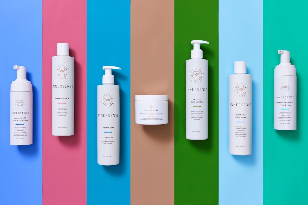 Collection of hair care products from the brand Innersense arranged on colorful backgrounds. Innersense salon Ballard, Seattle