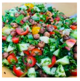 Colorful chopped salad with vegetables and possibly some herbs.
