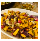 A plate of roasted squash, beans, and vegetables.