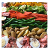 Assorted fresh vegetables including broccoli, carrots, green beans, potatoes, and cherry tomatoes, displayed in a colorful arrangement.