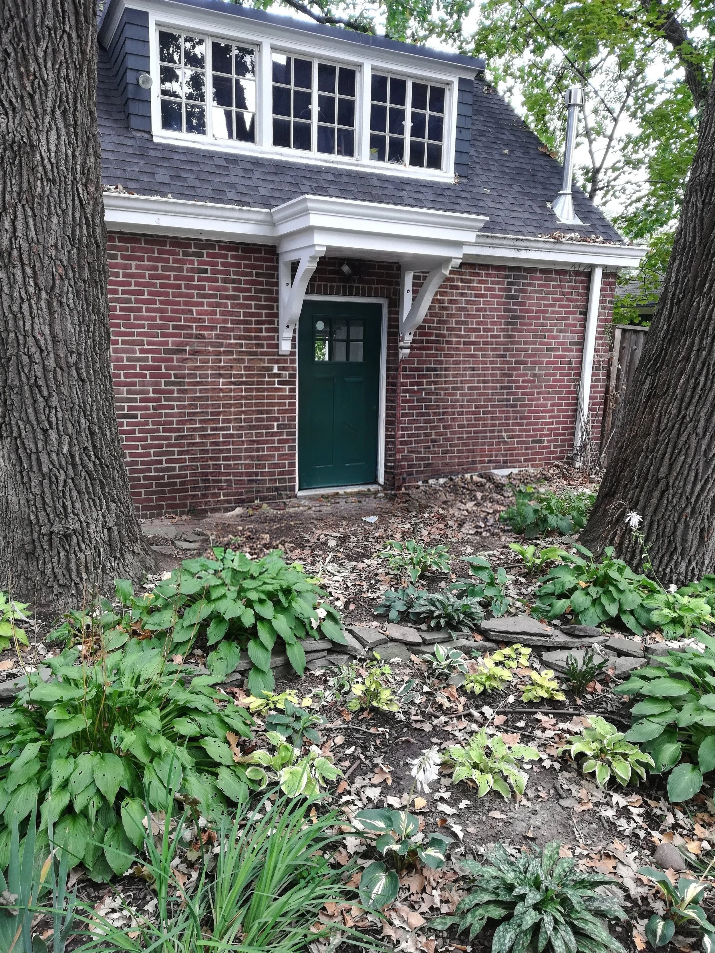 Exterior renovation featuring custom garage overhang and dormer addition in St Paul MN.