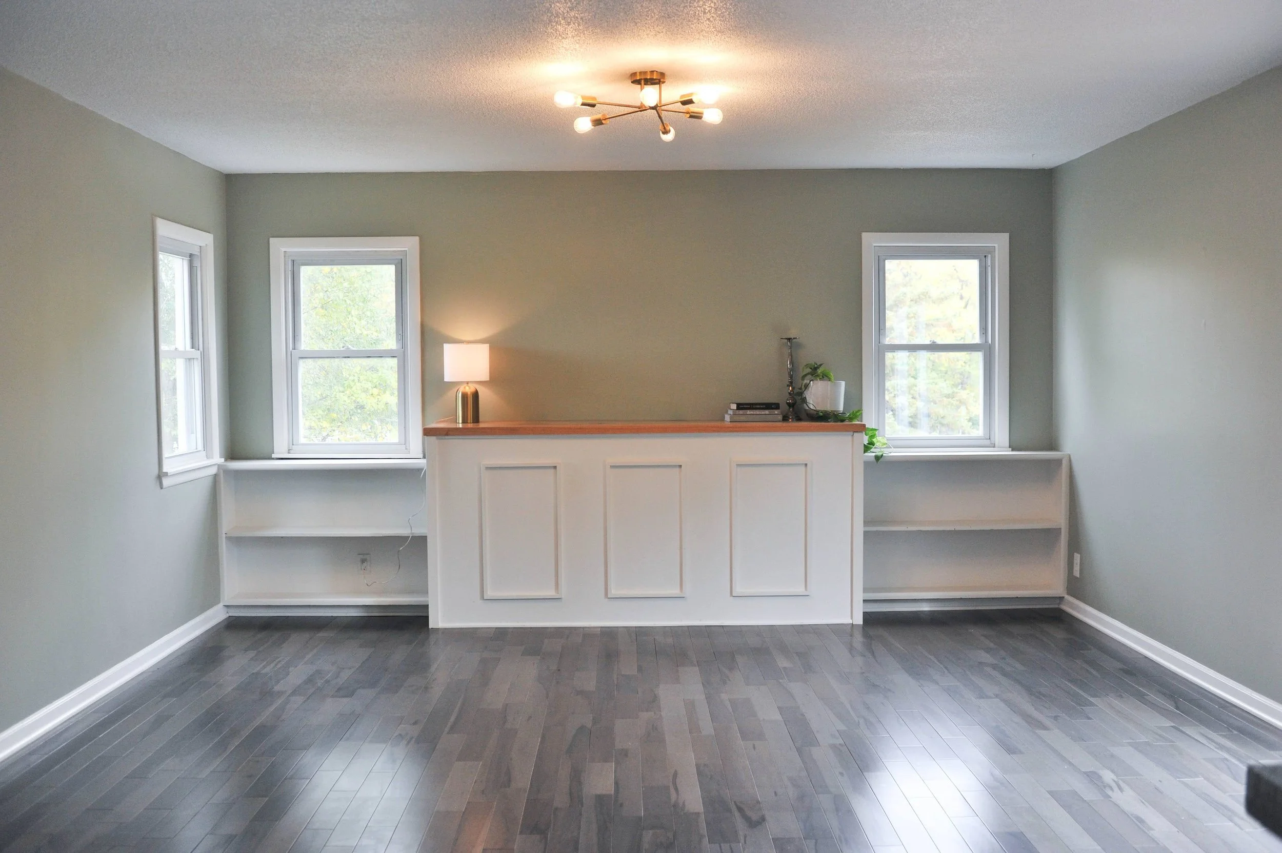 Built in shelves with custom piece covering abandoned fireplace 