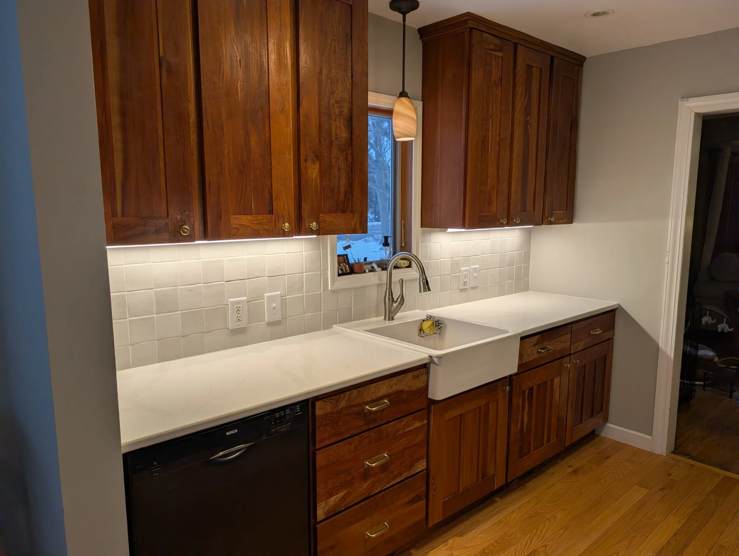 Hickory wood cabinetry, quartz countertops, and zellige backsplash tile in Maplewood MN kitchen remodel