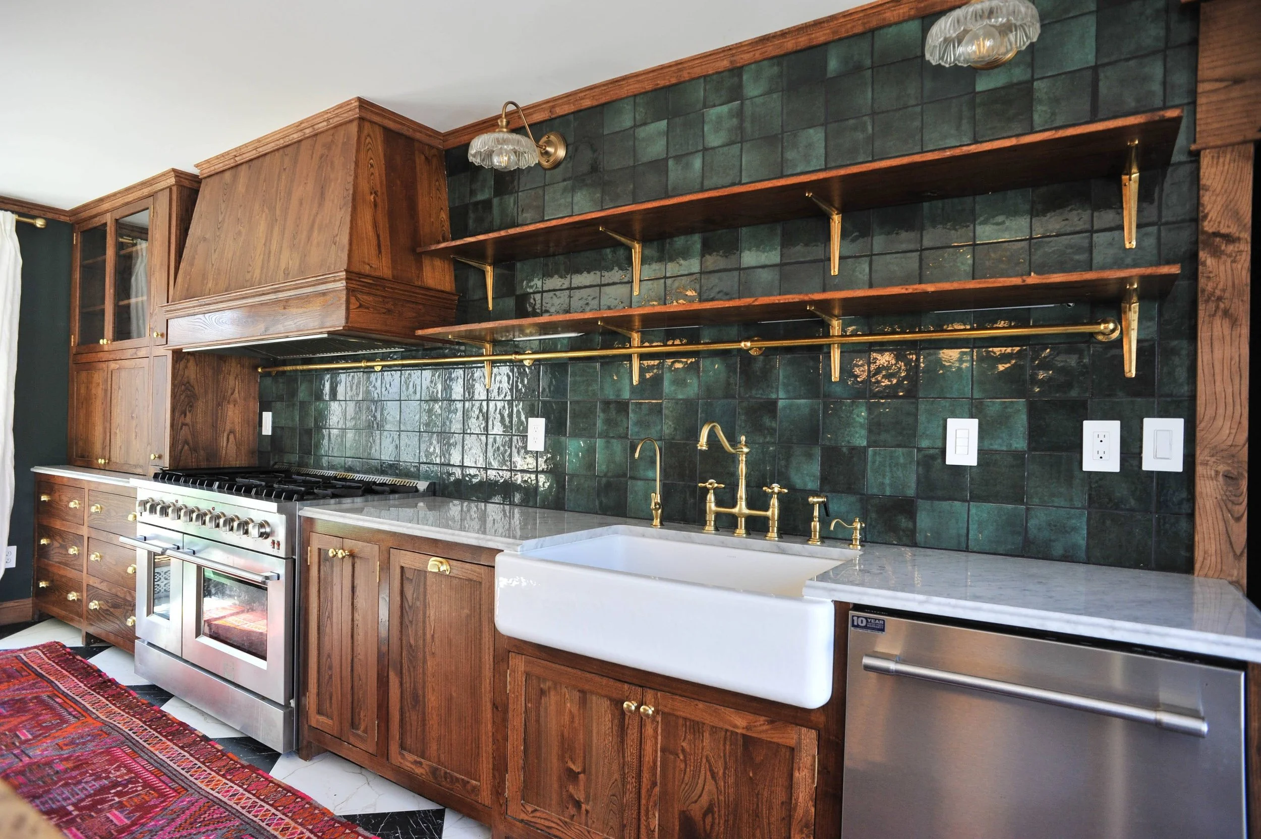 Custom wood kitchen cabinets with farmhouse sink and brass faucet in kitchen remodel.