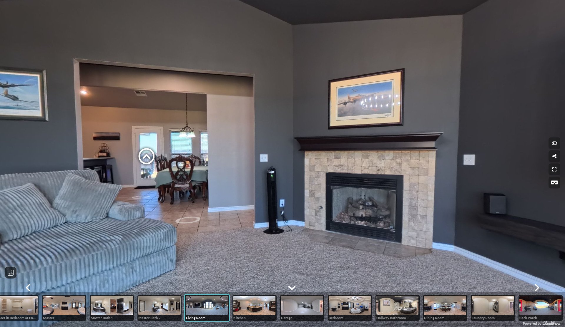 Maricopa AZ 3D virtual tour interface showing a living room corner with fireplace, TV wall, and room thumbnail strip