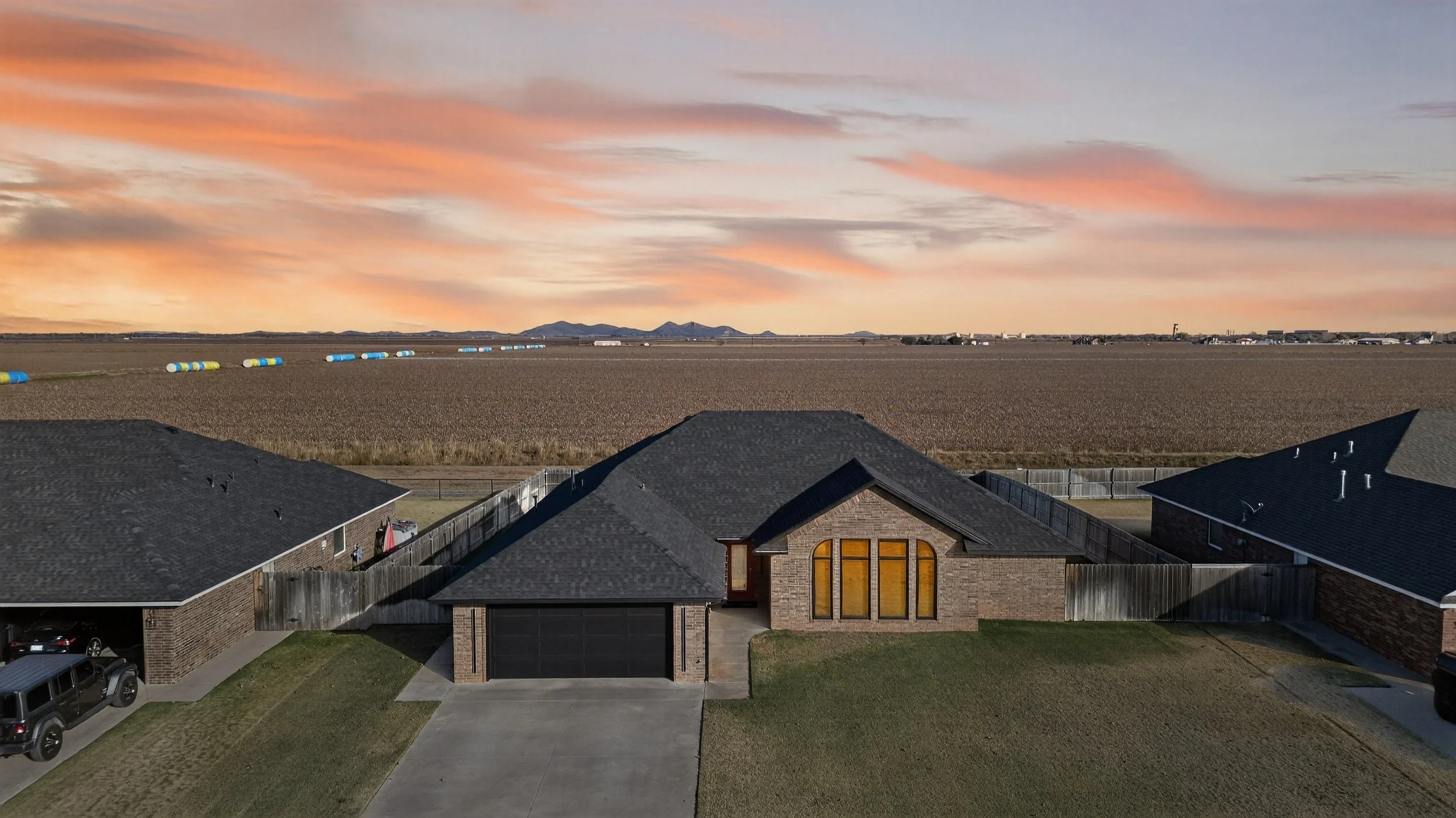 Maricopa AZ drone real estate photography: aerial of a home at sunset showing lot layout and open land