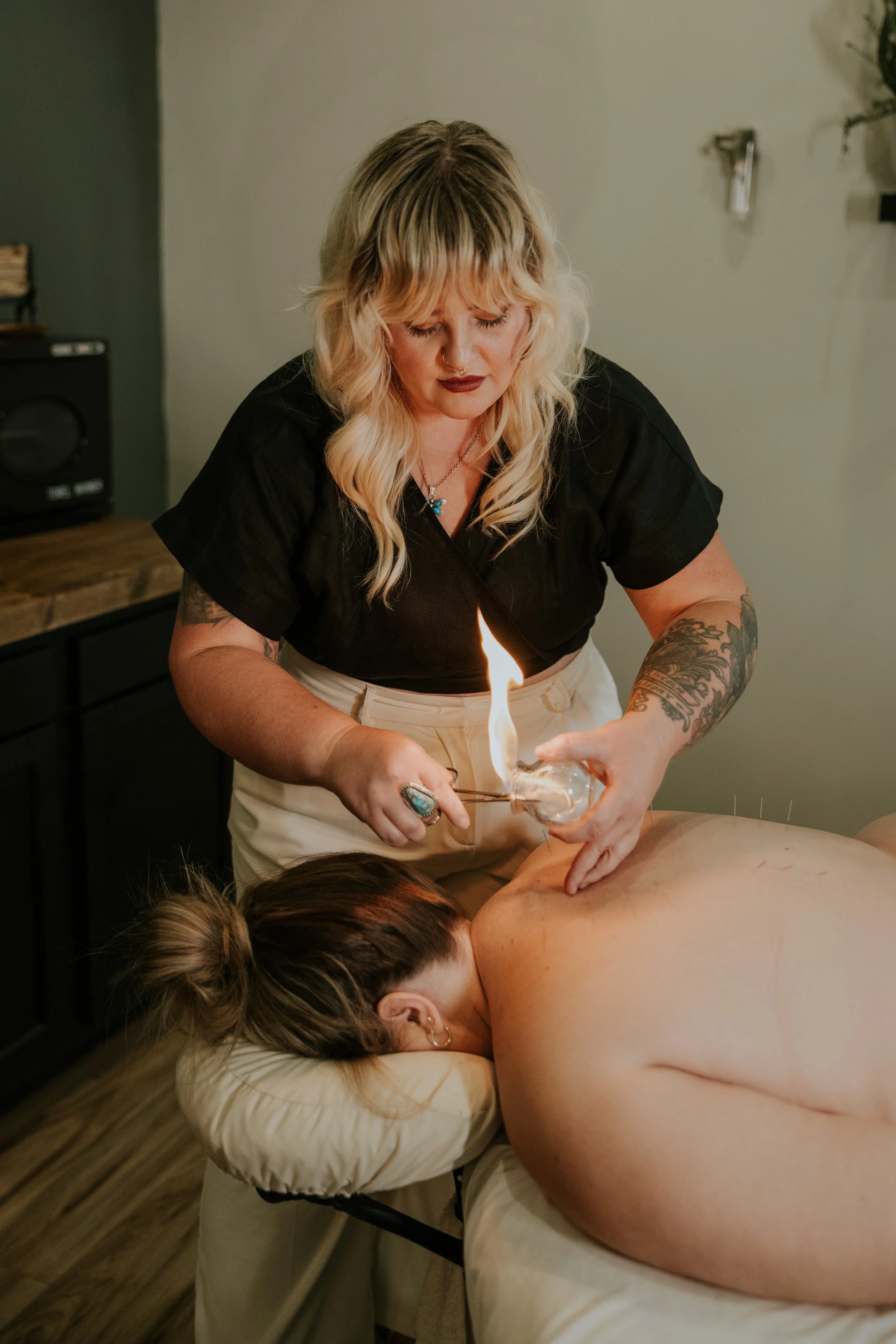 Fire cupping therapy session at Linc + Lani in Knoxville, Tennessee, with practitioner providing bodywork treatment to a client.