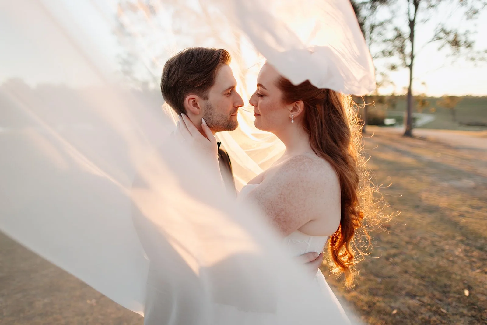 Bride and groom sharing a kiss in the garden
