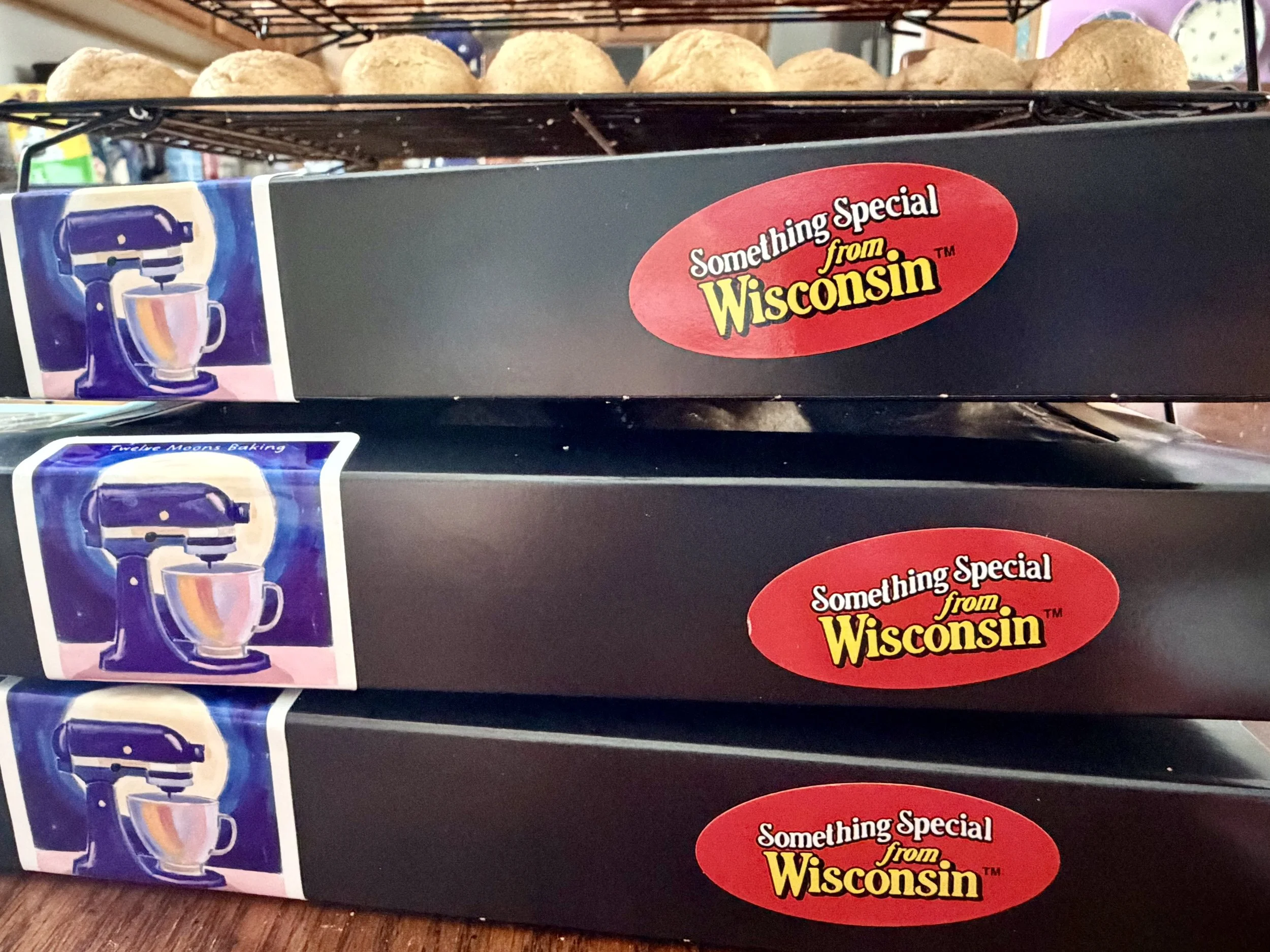 A stack of three boxes, each containing 12 home-baked cookies from Wisconsin cottage bakery Twelve Moons Baking LLC